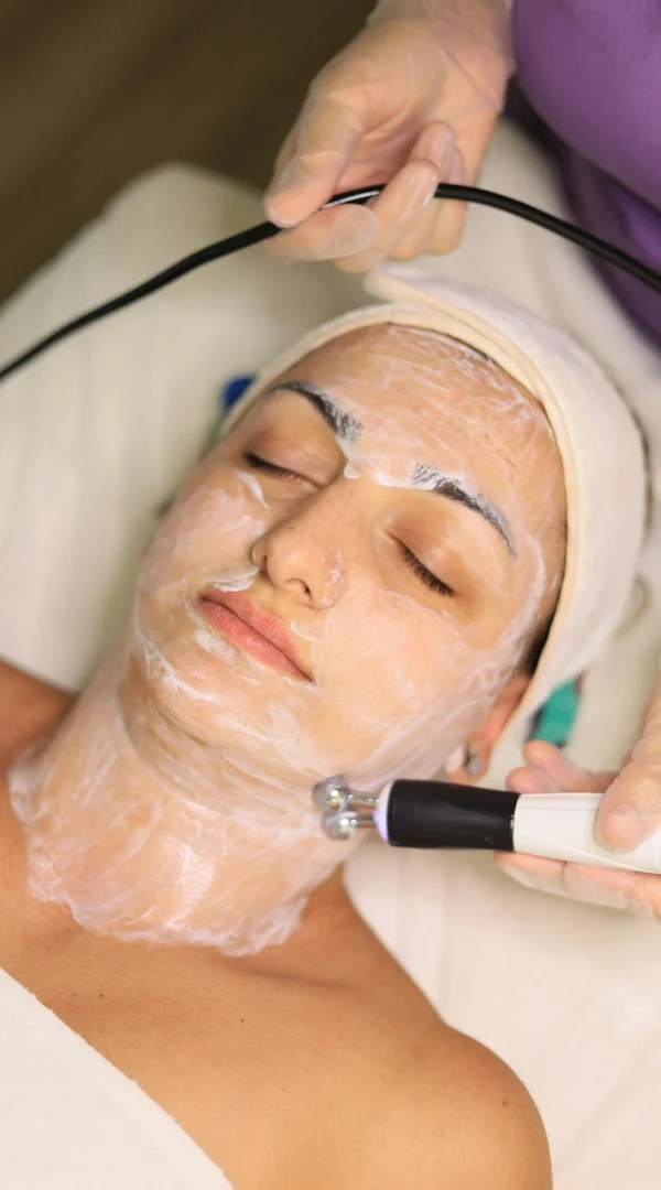 Client receiving non-invasive facial skin microcurrent treatment in Mt. Prospect.