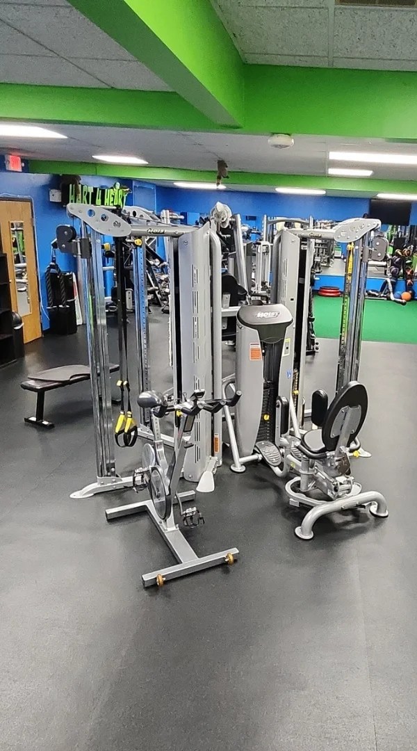 Multi-station cable machine setup on a gym floor in Schaumburg.