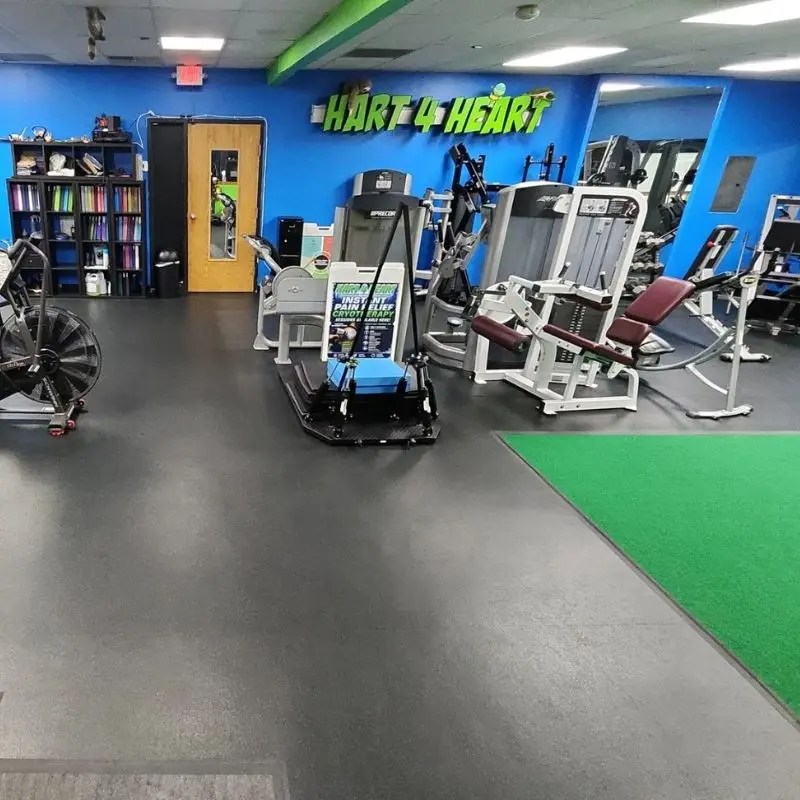 A vibrant fitness training area with turf and the Hart 4 Heart sign inside a private personal training studio in Schaumburg, IL.