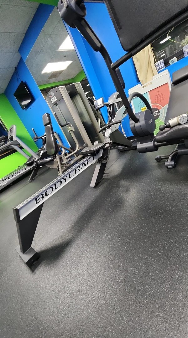 Bodycraft rowing machine on dark rubber floor in a personal training studio in Schaumburg.